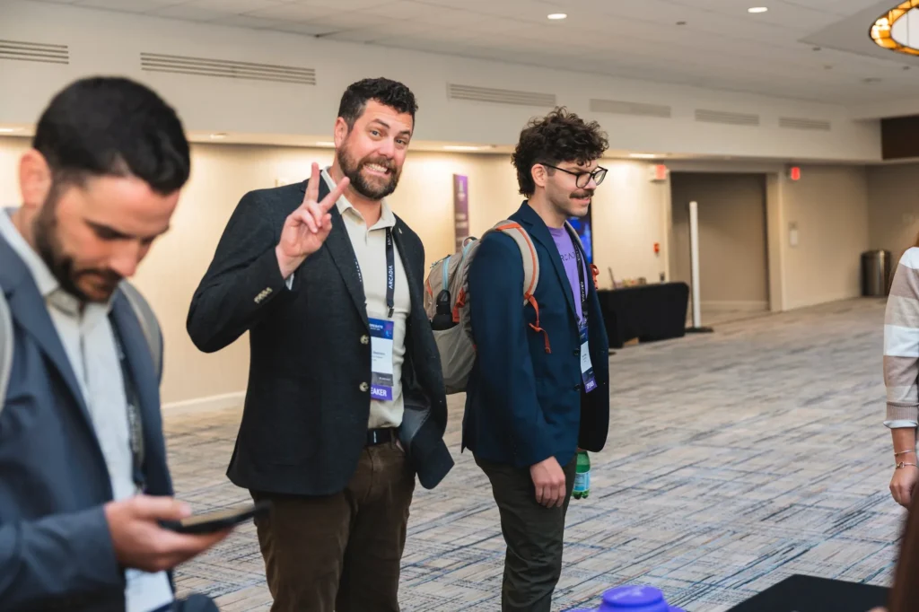 aggregate-2026-philadelphia-attendees-posing-in-conference-hallway