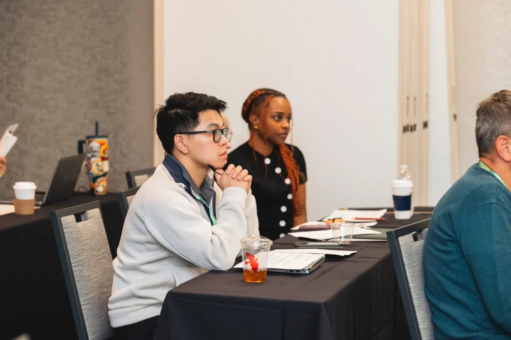 aggregate-2026-philadelphia-attendees-seated-at-table-listening