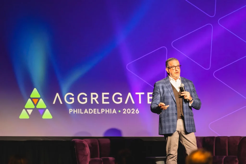 aggregate-2026-philadelphia-speaker-with-microphone-in-front-of-aggregate-logo